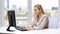 Young businesswoman with computer typing at office