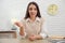 Young businesswoman conducting webinar at desk in room