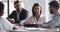 Young businesswoman consulting clients partners sitting at conference table