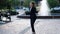 Young businesswoman dancing outside office, expressing happiness and success