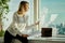 Young businesswoman with documents is looking through a window in a skyscraper