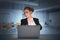 Young businesswoman financial analyst wearing suit is sitting at office space and looking at laptop screen and showing stop