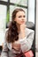 Young businesswoman with folders sitting in chair