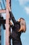 young businesswoman in formal wear climbing stairs on rooftop.