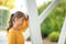 Young businesswoman leaning against column