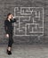 Young businesswoman looking at the labyrinth