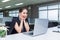 Young businesswoman looking at laptop screen, celebrating receiving good news