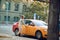 Young businesswoman opening door of a cab, smiling