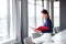 Young businesswoman reading file while sitting on conference table in office