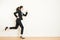 Young businesswoman with running on white background