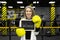 Young businesswoman in a suit in a boxing ring wearing gloves holds a sign with the inscription winner