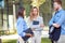 Young businesswoman talking to a two colleagues, male and female