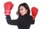Young businesswoman using boxing gloves