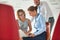 Young businesswoman using laptop while sitting amidst colleagues at new office