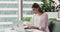 Young businesswoman using laptop writing notes sit at office desk