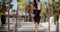 Young businesswoman walking through a park