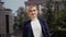 Young businesswoman walks down the street near a beautiful office building. Blond hair is removed, the girl is dressed