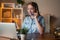 Young businesswoman wear wireless headset for video conference calling on laptop at her working place. Online studying. Lovely job