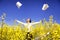 Young businesswoman among yellow flowers throw papers freedom