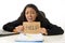 Young busy desperate Latin businesswoman holding help sign sitting at office desk in stress worried