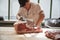 Young butcher sawing meat for sale at a butcher\'s shop