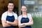 Young cafe owners in doorway