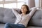 Young calm woman chilling relaxing leaning on comfortable sofa