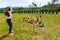 Young camp leader playing charades with preschoolers