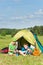 Young camping couple cooking meal outside tent