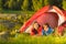 Young camping couple lying in tent