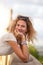 Young carefree Caucasian woman with curly hair smiling outside