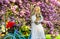 Young and carefree. girl with vintage bicycle in pink sakura alley. blooming tree in spring time. natural female beauty