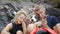 Young carefree hiker tourits relaxing with dog near waterfall smiling and pointing on camera. Koh Phangan, Thailand. HD