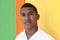 Young caribbean guy in front of a colorful wall