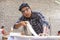 Young carpenter applying wood vinyl into a furniture