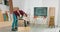 Young carpenter cuts an osb board with a jigsaw Craftsman\'s hands in cloth protective gloves The jigsaw blade cuts