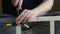 Young carpenter, handyman working with wood, using a screwdriver