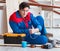 The young carpenter taking break from working with wooden planks