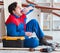 Young carpenter taking break from working with wooden planks