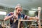 Young carpenter women using measuring tape looking wood size at workspace. craftsman profession in wood factory