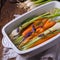 Young carrots and spring onions prepared for baking