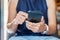 Young casual Businesswoman holding and using smartphone for sms messages, hipster woman typing touchscreen cell phone in the cafe