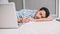 Young Caucasian asleep freelancer business man sleeping near to laptop with eyes closed while lying on the floor at home. Quick