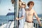 Young caucasian attractive couple navigating a yacht in caribbean sea