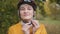 Young caucasian blond woman putting safety helmet on her head in the park