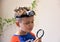 Young Caucasian boy with head torch lamp looking through a magnifier glass