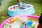 Young caucasian boy in inflatable pool enjoying water