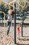 Young Caucasian boys friends hanging on monkey bars and pull-up bars in park on playground. Summer outdoor activity for kids.