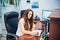 Young caucasian business lady sitting on her workplace in office. Female entrepreneurship. Portrait of skilled manager satisfied