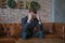 Young caucasian business man in formal suit sitting on sofa clutching his head